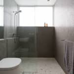 Modern walk in shower with mosaic full height tiles and terrazzo floor